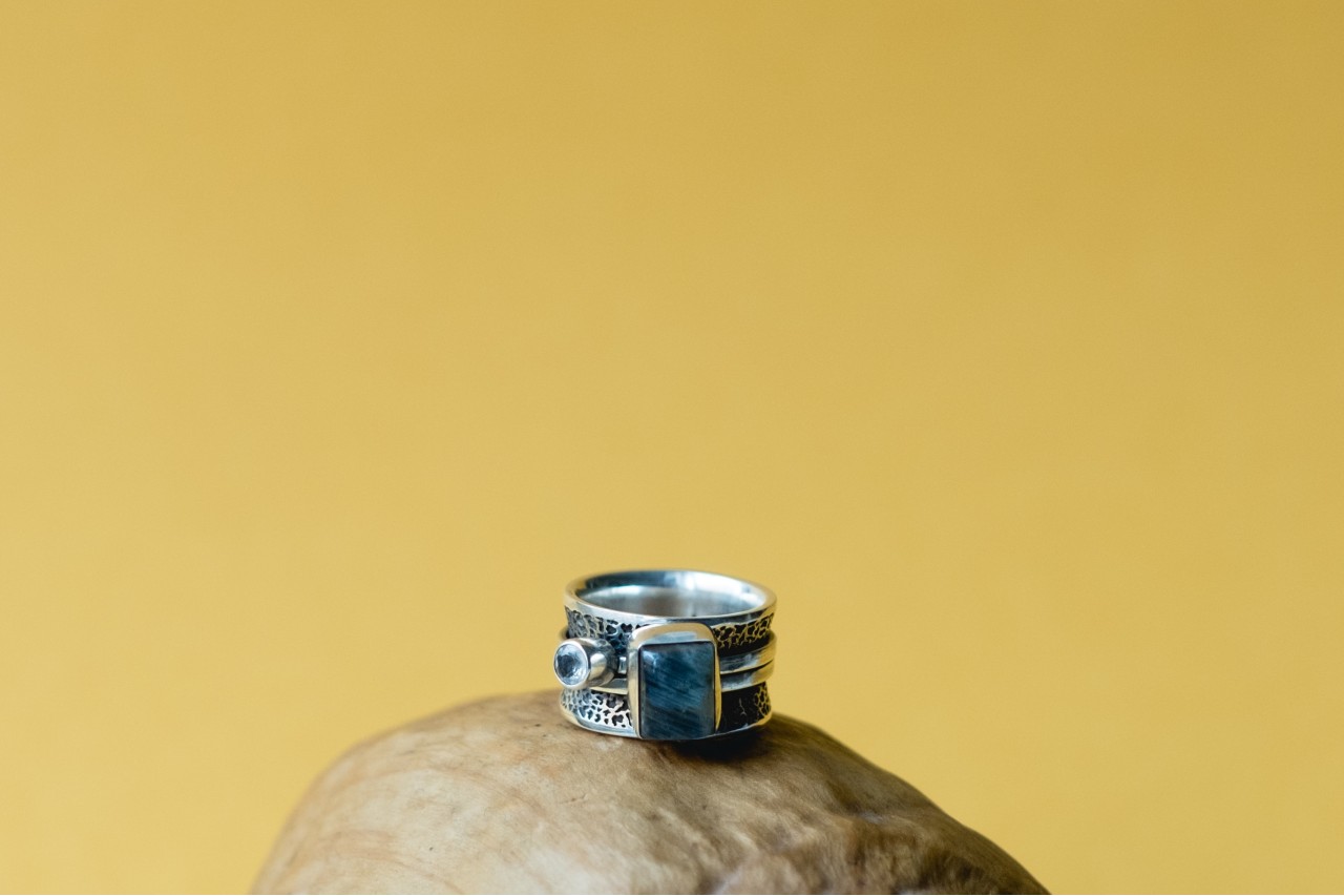 Sterling silver and labradorite fashion ring on a rock.