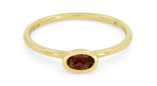 a yellow gold fashion ring featuring a bezel set brown garnet