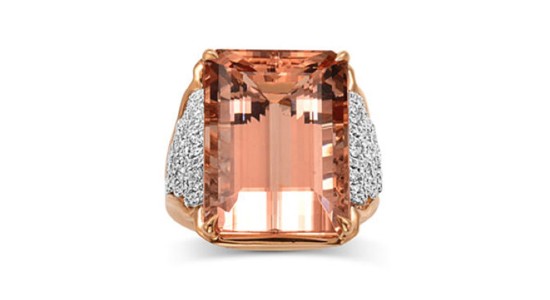 a rose gold ring featuring a large pink emerald cut gemstone and diamond accents